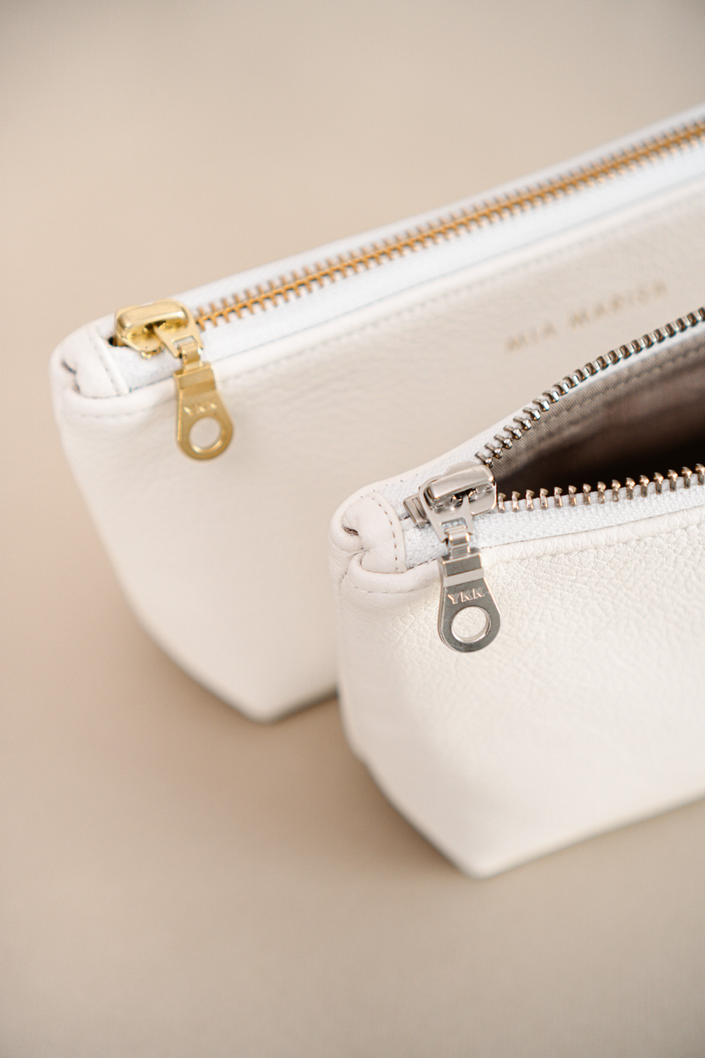 gold and silver zipper on white small case